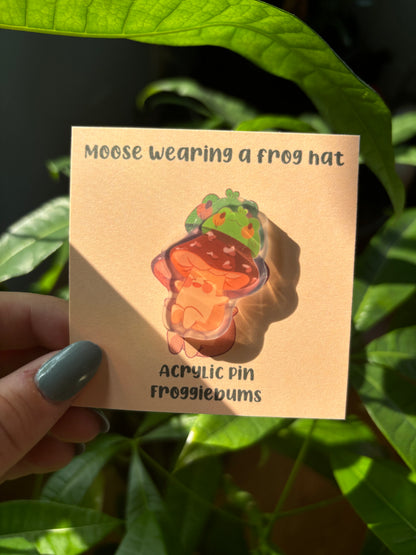 moose wearing a frog hat pin