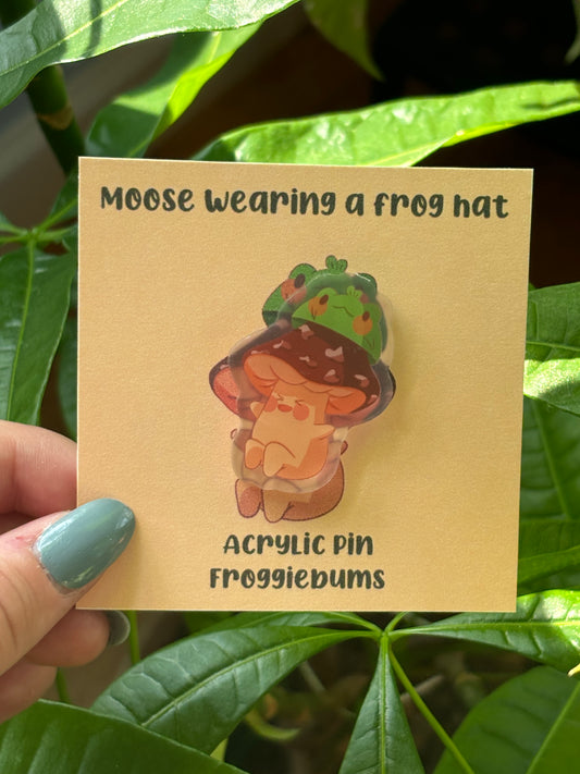 moose wearing a frog hat pin